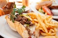 American beef cheese steak sub sandwich and fries on white plat Royalty Free Stock Photo