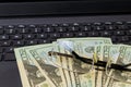American twenty dollar banknotes, glasses on the keyboard laptop money on the Internet, freelancer