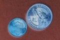 American US coins of the face value of 1 dollar and 1 cent close up. Dark inverted illustration. Top view from above. National or