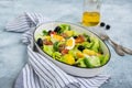 American version of Nicoise salad with canned tuna, boiled potatoes and green asparagus beans in an oval white dish on a gray Royalty Free Stock Photo