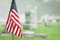 American veteran flag in foggy cemetery Royalty Free Stock Photo