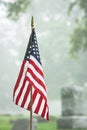 American veteran flag in foggy cemetery Royalty Free Stock Photo