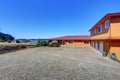 American waterfront house, orange exterior paint and three garage spaces