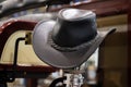 American West rodeo cowboy black leather hat in old wood ranch barn Royalty Free Stock Photo