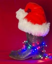 American West traditional boots and Santa hat on christmas red b Royalty Free Stock Photo