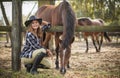 American woman on a rancho with a horse, hippotherapy