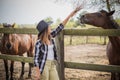 American woman on a rancho with a horse, hippotherapy