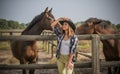 American woman on a rancho with a horse, hippotherapy Royalty Free Stock Photo