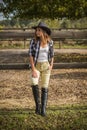 American woman on a rancho with a horse, hippotherapy