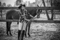 American woman on a rancho with a horse, hippotherapy