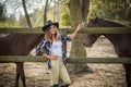 American woman on a rancho with a horse, hippotherapy