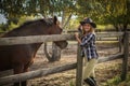 American woman on a rancho with a horse, hippotherapy