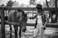 American woman on a rancho with a horse, hippotherapy