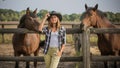 American woman on a rancho with a horse, hippotherapy
