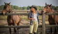 American woman on a rancho with a horse, hippotherapy Royalty Free Stock Photo