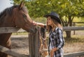 American woman on a rancho with a horse, hippotherapy