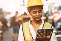 American women worker in heavy Industry maintenance engineer happy working wearing safety uniform and helmet using tablet computer Royalty Free Stock Photo