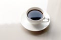 Americano coffee is black coffee in a white cup. On a white table It`s healthy coffee Refreshes and energizes And has a refreshin