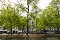 Amesterdam, Holland Ã¢â¬â 2019. Cars and bicycles parked near canal of river Amstel in narrow streets of Amsterdam city. Old dutch Royalty Free Stock Photo