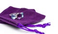 Amethyst with blue topaz and white sapphire jewel or gems ring on violet velvet bag. Collection of natural gemstones accessories. Royalty Free Stock Photo
