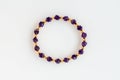 Amethyst Bracelet with Polygonal Beads and Round Gold Beads Isolated on White Royalty Free Stock Photo