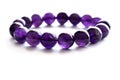 Amethyst bracelet on white background. Spiritual and healing crystal gemstone. Purple or violet crystal stone.