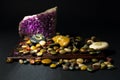 Amethyst crystal and colorful stones over a wooden board Royalty Free Stock Photo