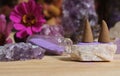 Amethyst Crystals With Flowers and Incense Cones on Meditation Table Royalty Free Stock Photo