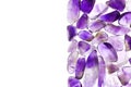 Amethyst heap stones texture on half white light isolated background. Place for text