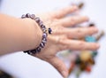 Amethyst mineral bracelets on a young womans wrist