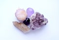 Amethyst purple natural stones in different varieties. Tumbled stones, amethyst druse and cactus quartz crystals. Cactus quartz, Royalty Free Stock Photo