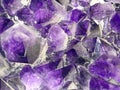 Abstract background made of amethyst crystals extreme close-up. Top view.