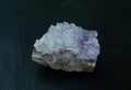 Amethyst violet variety of quartz from Brazil. Natural mineral stone on black background. Mineralogy, geology, magic of