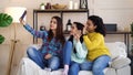 Amiable multiracial girls live streaming from home using smartphone