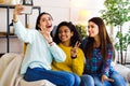 Amiable multiracial girls live streaming from home using smartphone