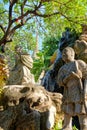 Amidst the ancient walls of a Bangkok temple, sculptures and vibrant plants intermingle, weaving a captivating narrative