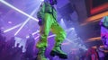 Amidst the flashing lights and techno music a man sports an oversized neon green suit complete with chunky platform Royalty Free Stock Photo