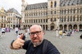 Cheerful Tourist& x27;s Thumbs-Up Selfie: Exploring Brussels& x27; Heart