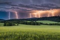 Amidst the rolling hills of the countryside, a dramatic lightning storm illuminates the landscape, casting eerie shadows