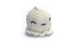 Miniature octopus keychain in white colors crocheted on a white background