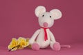 Cute little rat crocheted, handmade art. Amigurumi one white mouse with big ears and long nose sits on pink background Royalty Free Stock Photo