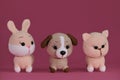 Amigurumi three pets dolls on pink background. DIY soft toys made of natural cotton and wool. Cute little kitten, puppy Royalty Free Stock Photo