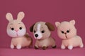 Amigurumi three pets dolls on pink background. DIY soft toys made of natural cotton and wool. Cute little kitten, puppy Royalty Free Stock Photo