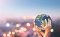 Amily hands holding earth global blurred city night Royalty Free Stock Photo