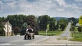 Amish Boy on a Small Wagon Ride Down on a Rural Road