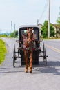 Amish Buggy carrying a woman and daughters in Pennsylvania USA