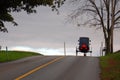 An Amish buggy crests a hill