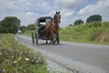 Amish buggy rolling down a rural road in Lancaster County Pennsylvania Royalty Free Stock Photo