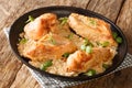 Amish chicken pieces baked in the flour and spices closeup in the plate. Horizontal