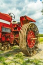 Amish country vintage red agricultural tractor with metal wheels on a field background in Lancaster, PA US Royalty Free Stock Photo